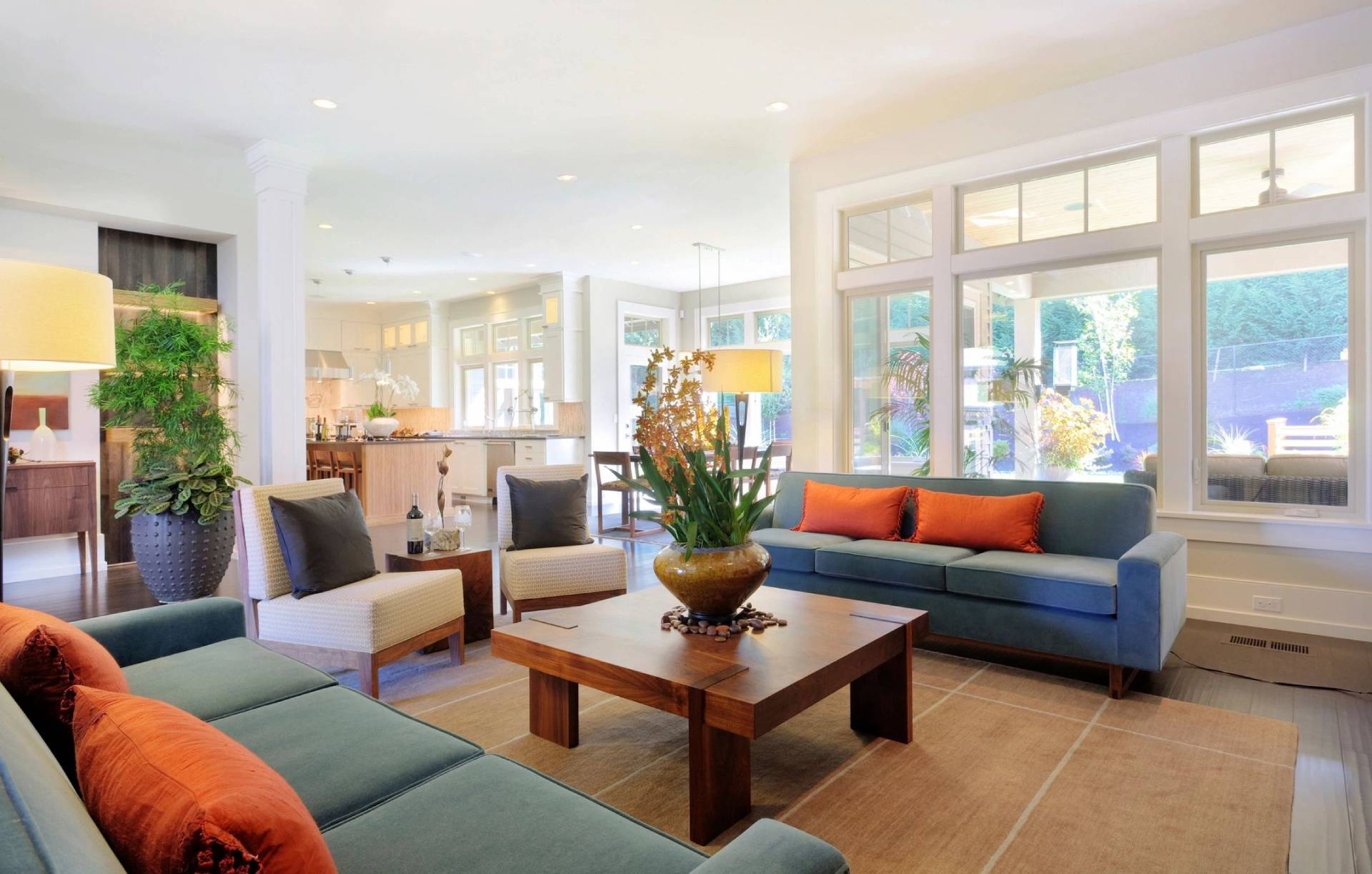 A living room with couches, tables and chairs.