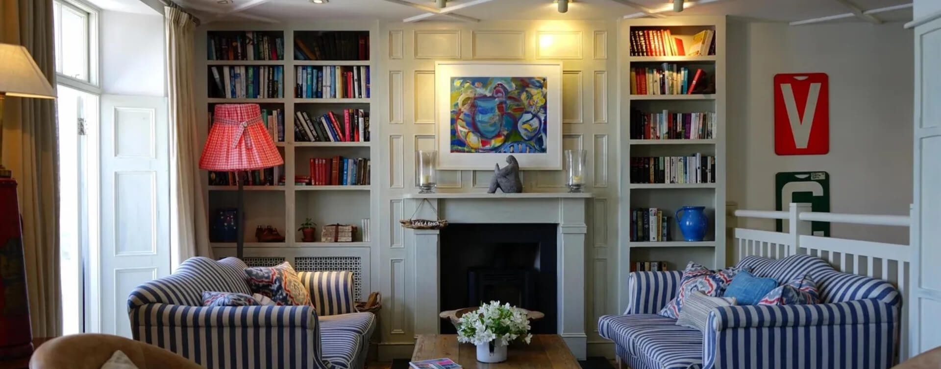 A living room with a fireplace and bookcases